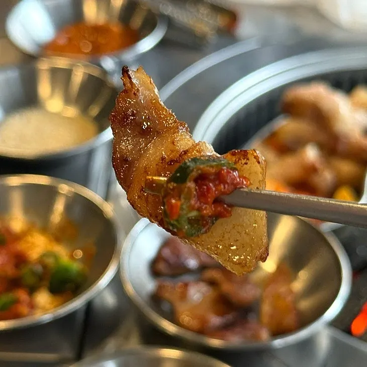 A piece of meat dipped in hairtail fish sauce