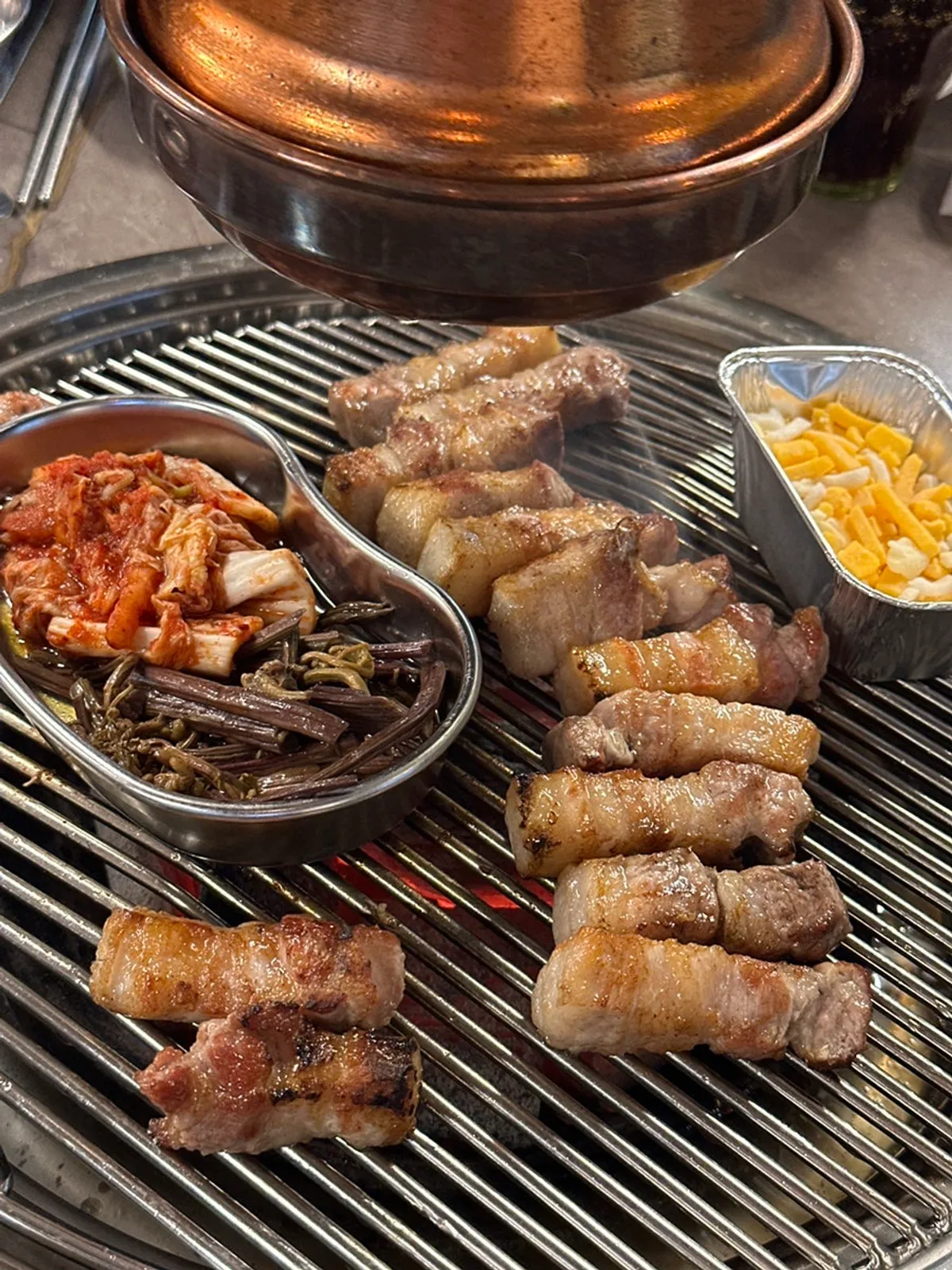 A piece of pork belly topped with myeongi-namul