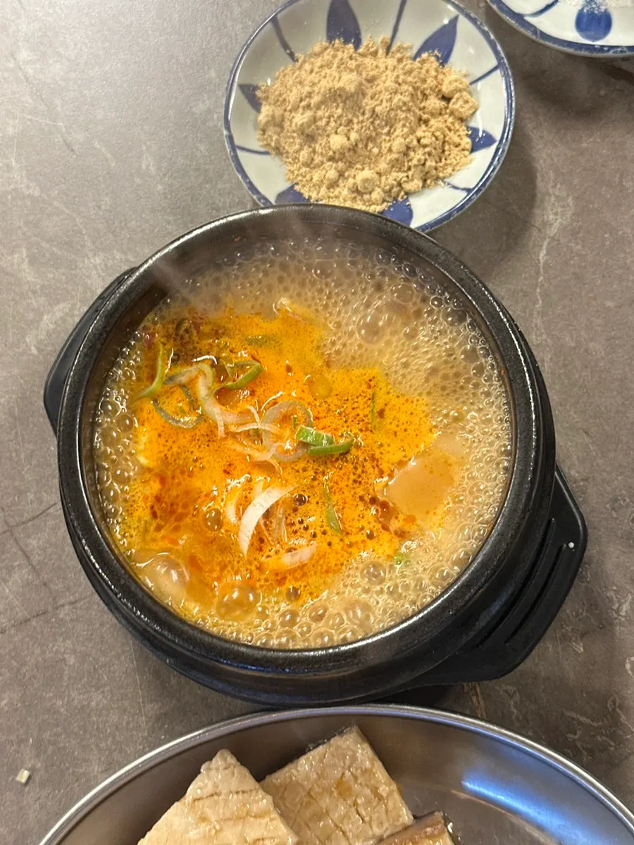 Bubbling sundubu-jjigae with a bowl of rice
