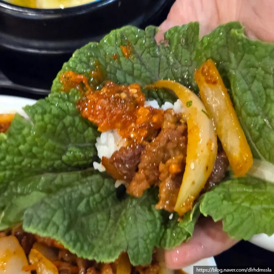 A bite of rice and pork wrapped up