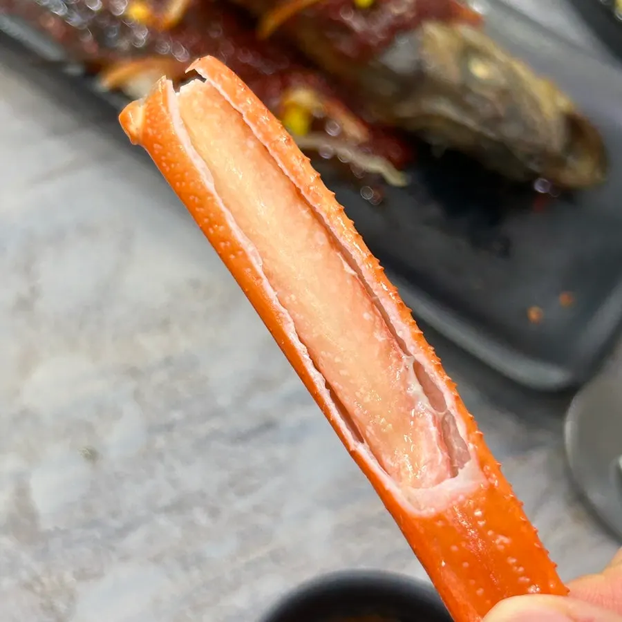 Picking meat from the red crab