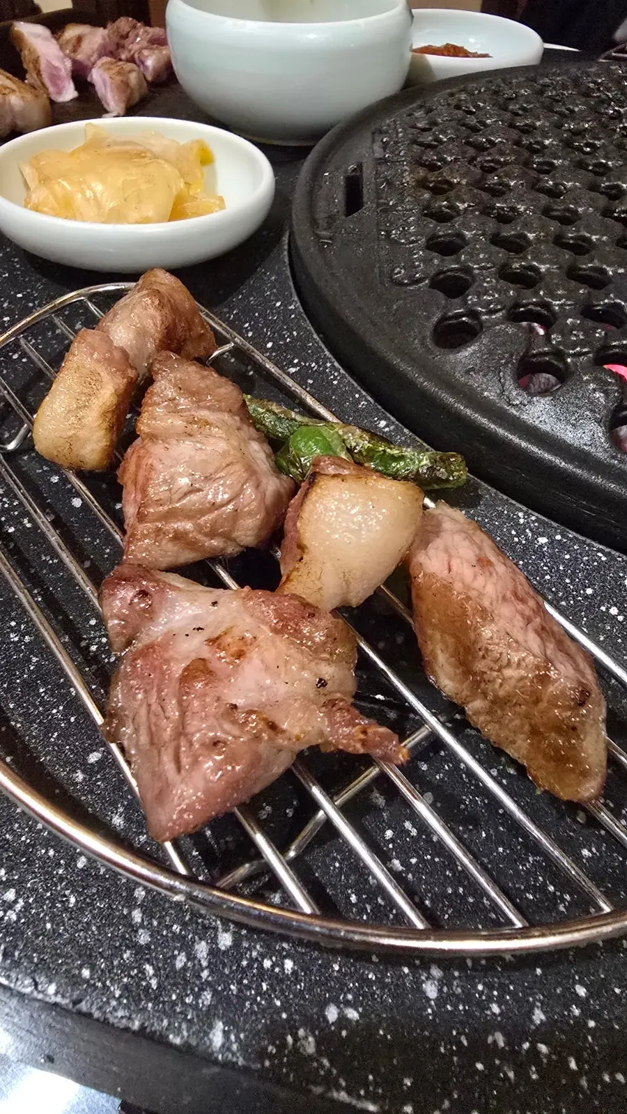 A piece of ogeopsal topped with ttaengcho sauce