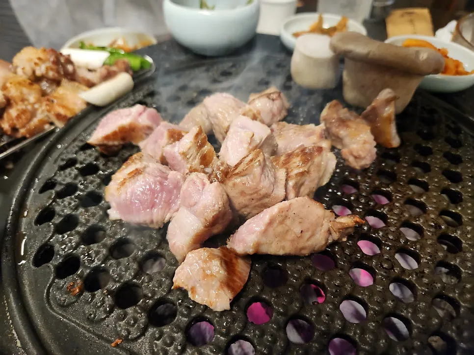 Aged pork cooking on the grill plate