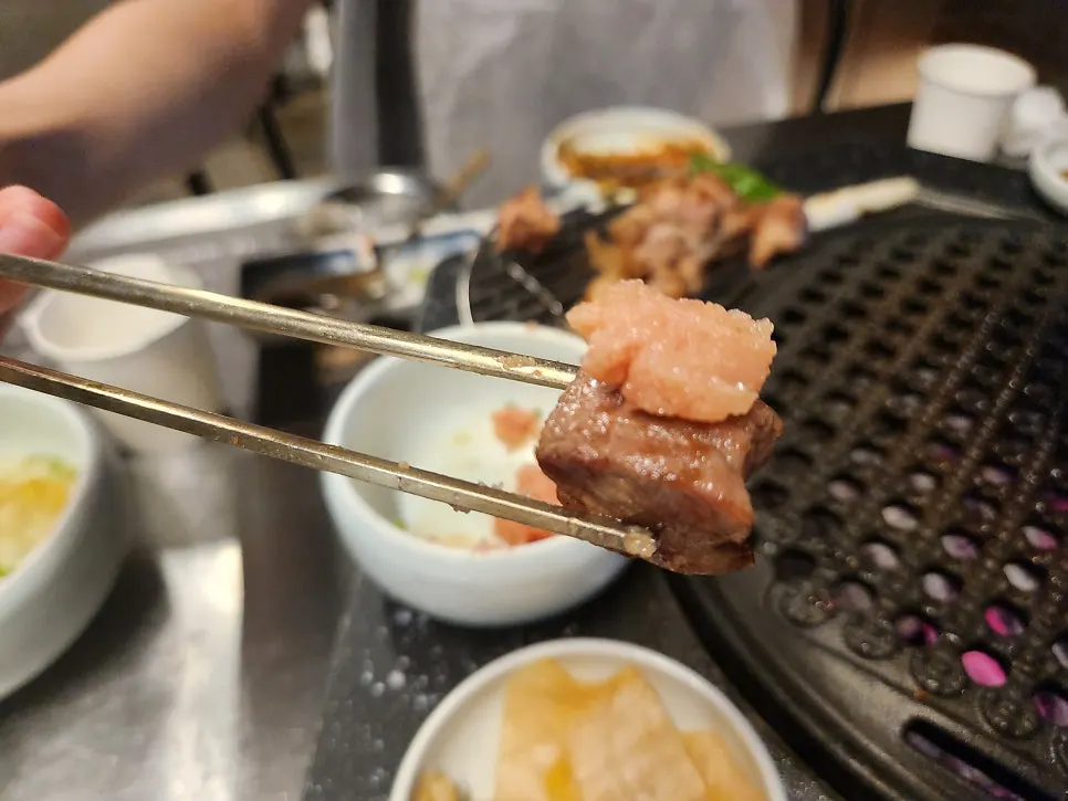 Piece of pork belly topped with shredded scallions