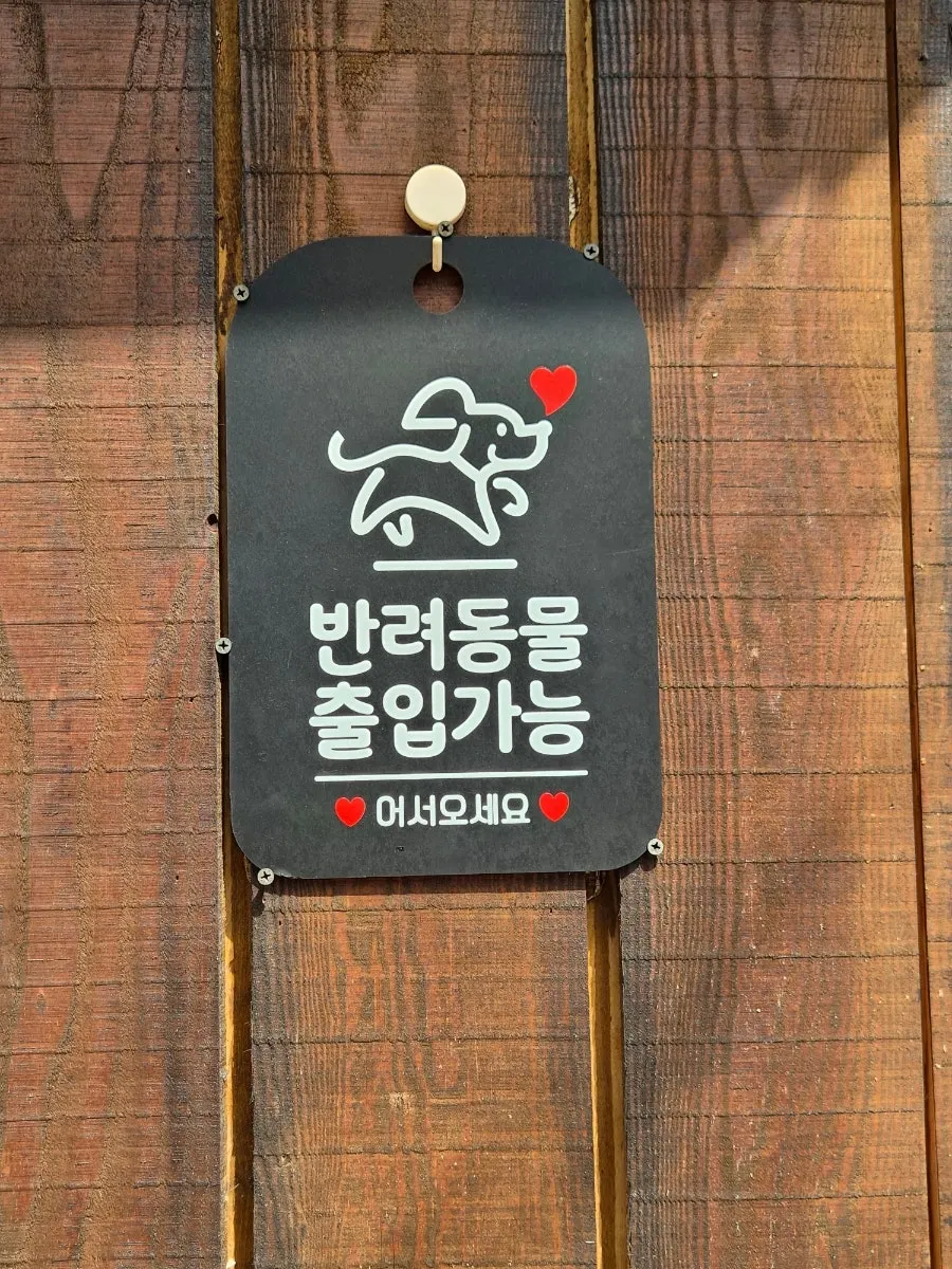 Certification panels and a menu stand next to the entrance