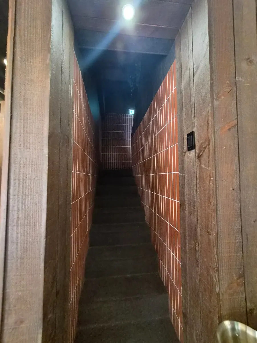 Meat aging inside a lit glass-door aging chamber