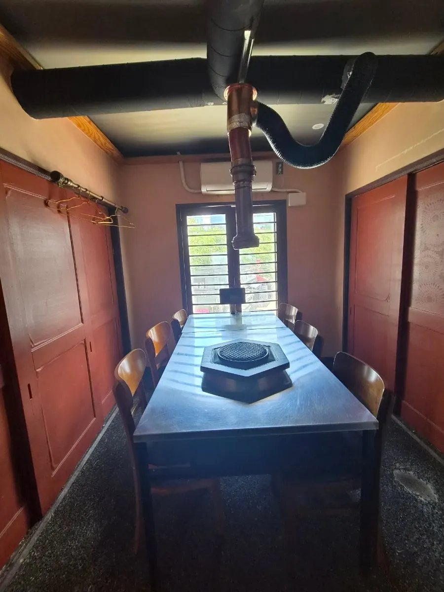 Group room interior with a long table and coat hooks