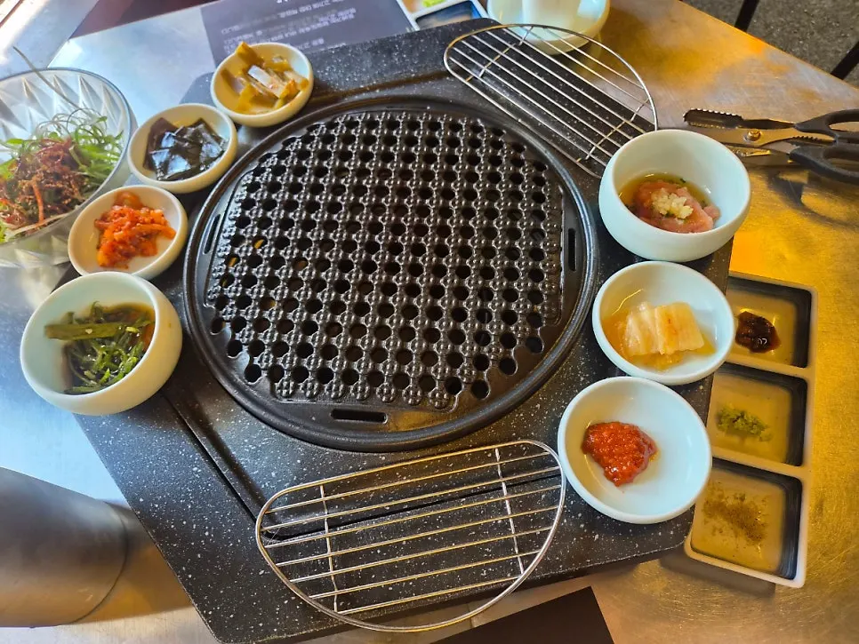 Side dishes arranged around the grill