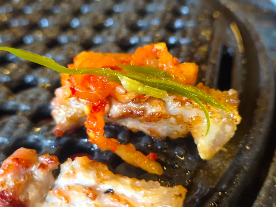 Meat paired with shishito pepper and green onion kimchi