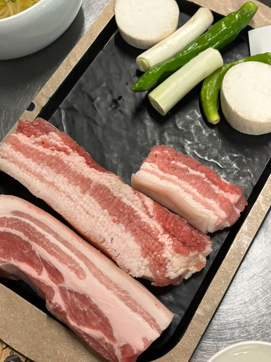Plate of scored raw snowflake pork belly