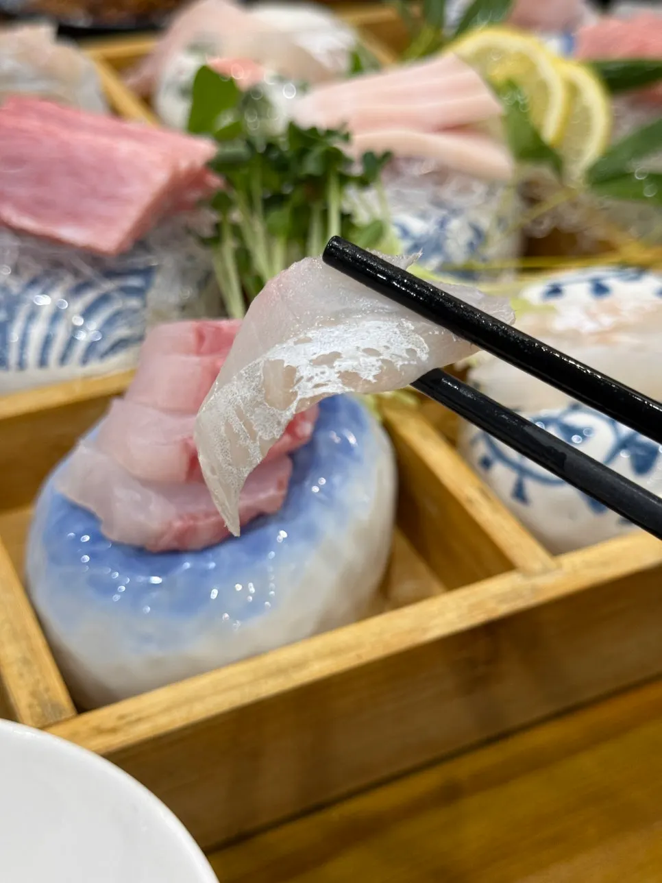 A piece of tuna sashimi dipped in soy sauce