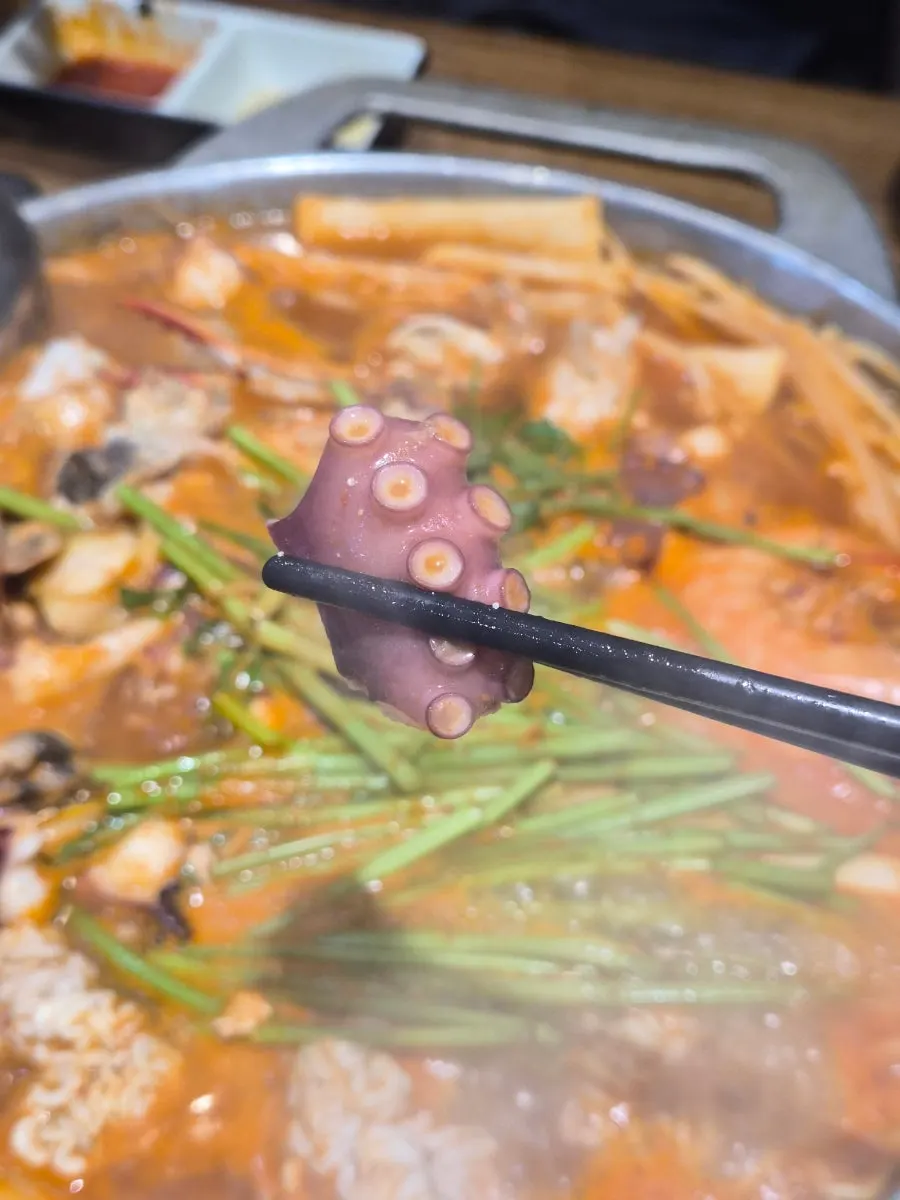 A bowl of seafood stew with rich broth