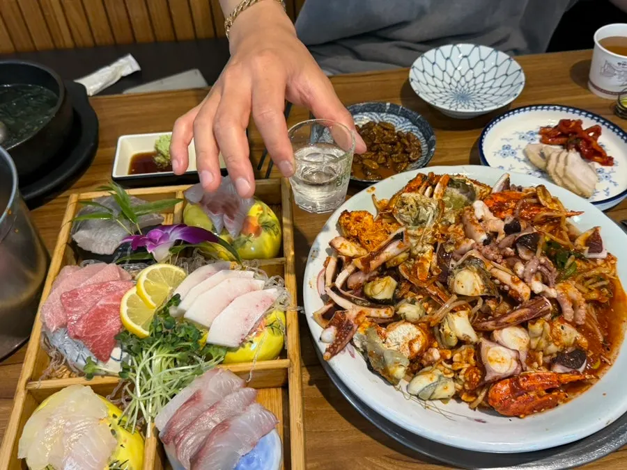Full table spread of the spicy seasoned seafood stew