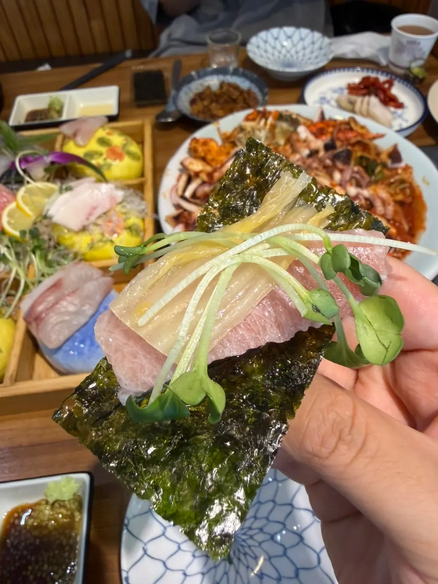Tuna sashimi wrapped in seaweed with mu-sprouts