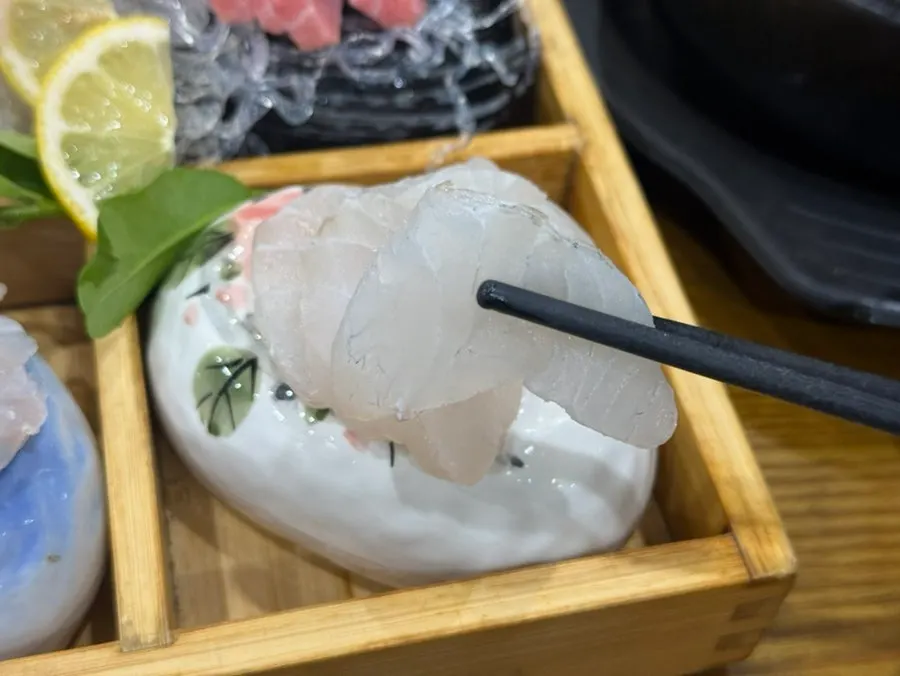 Plate of mixed sashimi neatly arranged with several kinds of fish