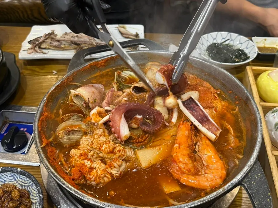 Seafood stew pot with abalone, shrimp, octopus, and clams
