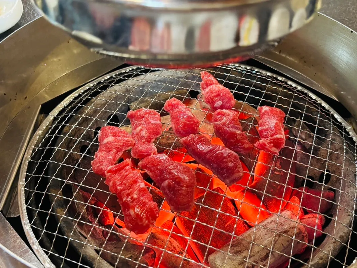 Grilling meat directly over the charcoal