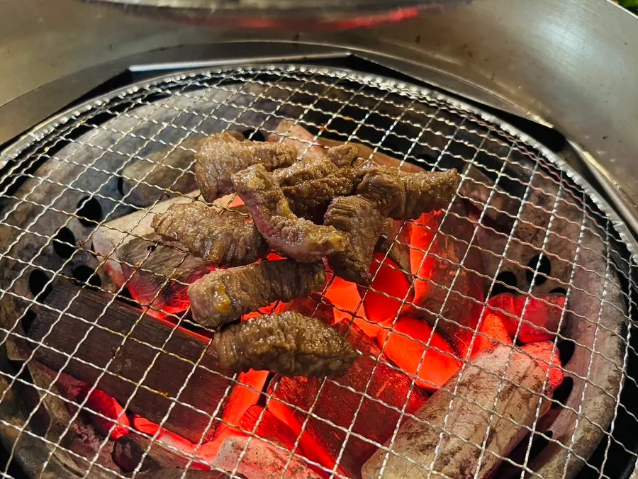 Meat sizzling with a smoky charcoal finish