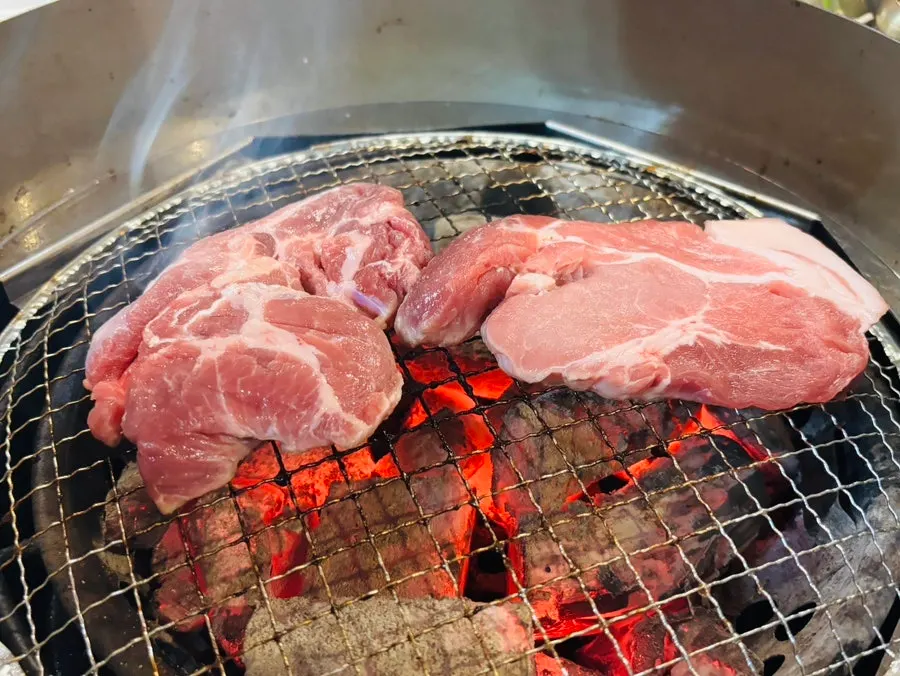 Meat finishing on the charcoal grill