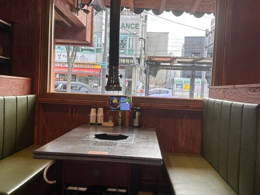 Dining hall interior with window seats at Dongbaek Hanokjip