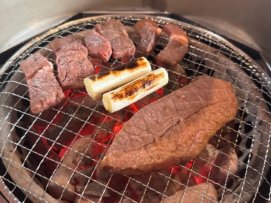 Scallions grilled alongside the meat