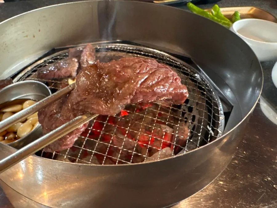 Close-up of chuck flap cooking on the charcoal