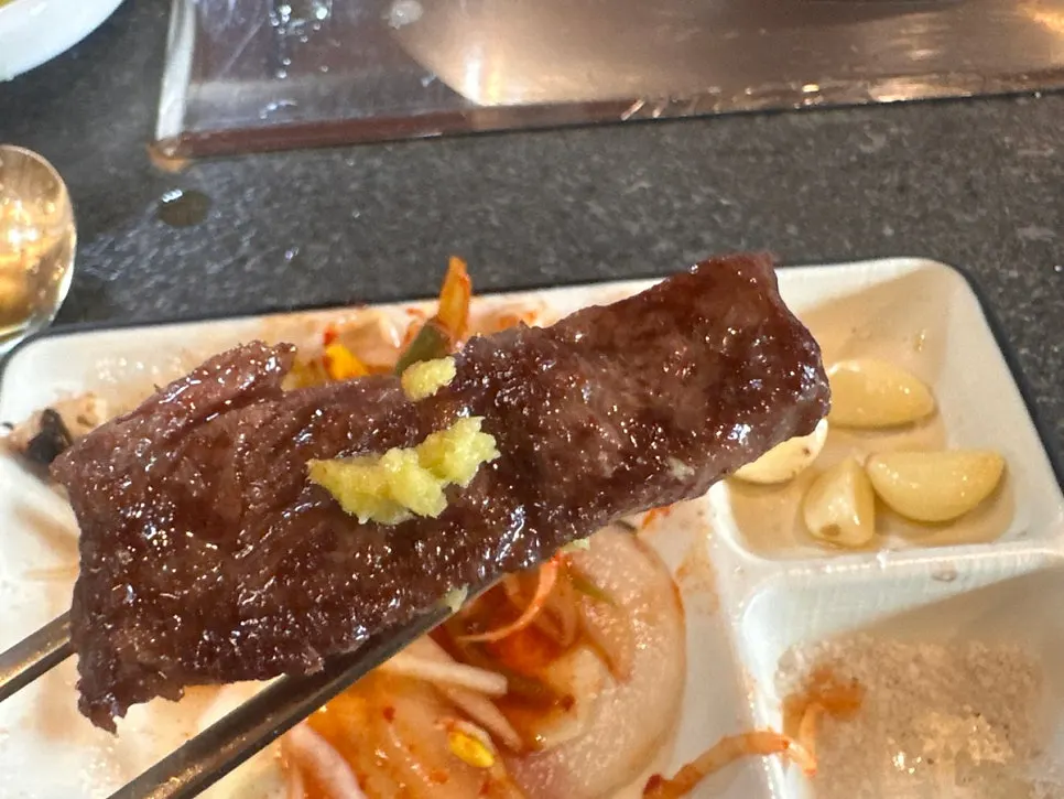 A piece of meat topped with wasabi