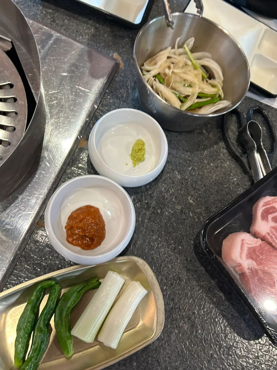 Table of side dishes including salad and seasoned vegetables