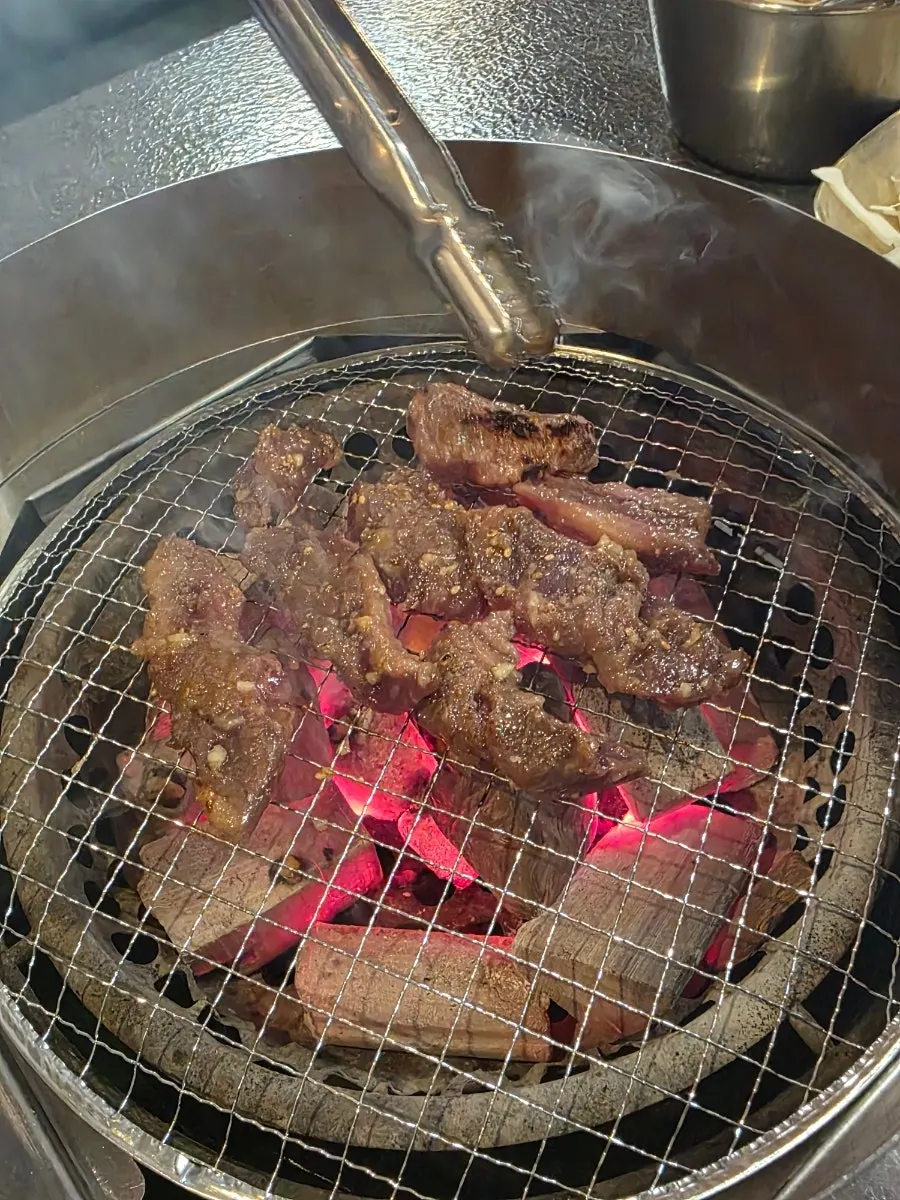 Marinated hwangjesal on the charcoal grill plate