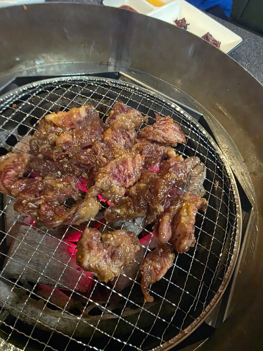 Marinated hwangjesal dipped in wasabi