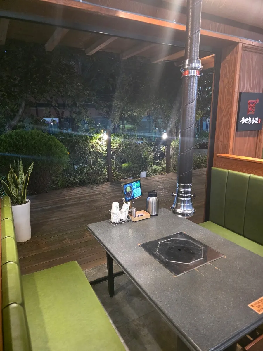 Garden-style smoking area near the parking lot entrance