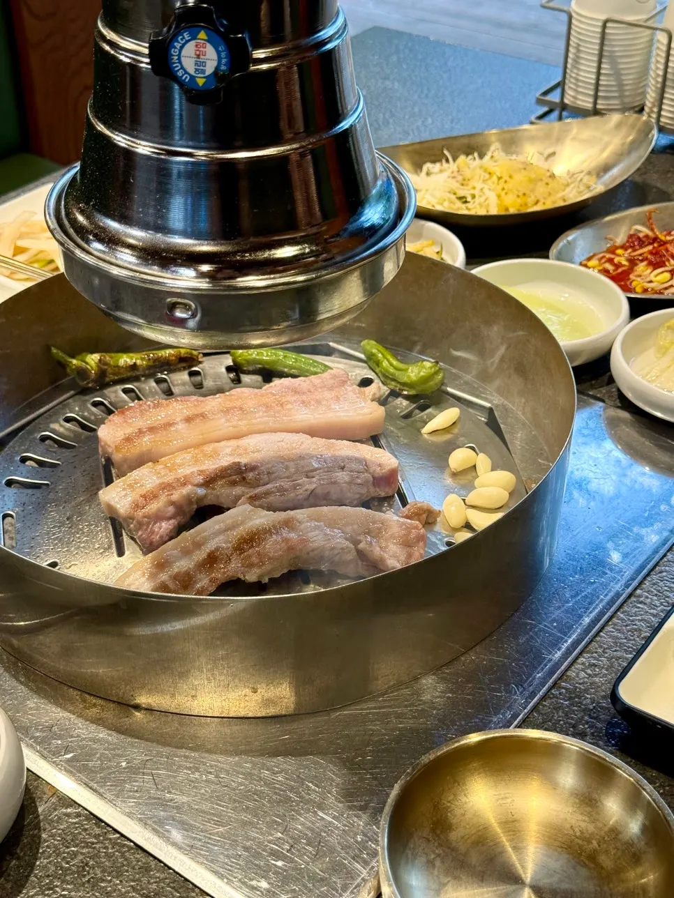 Pork turning golden brown over the charcoal grill