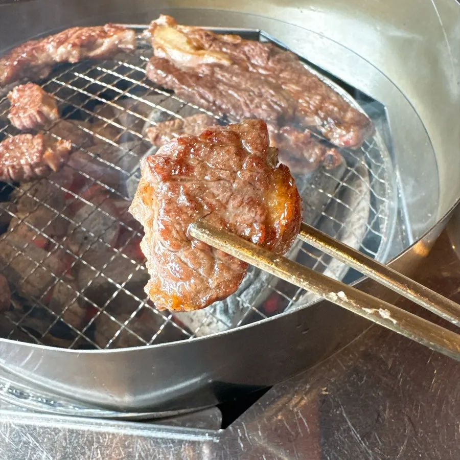 Hanwoo 1++ sirloin cooking over charcoal