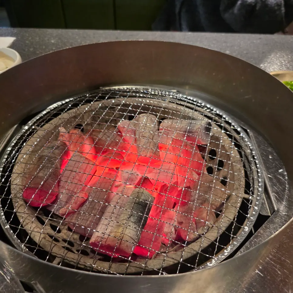 Charcoal and beef grill plate set on the table