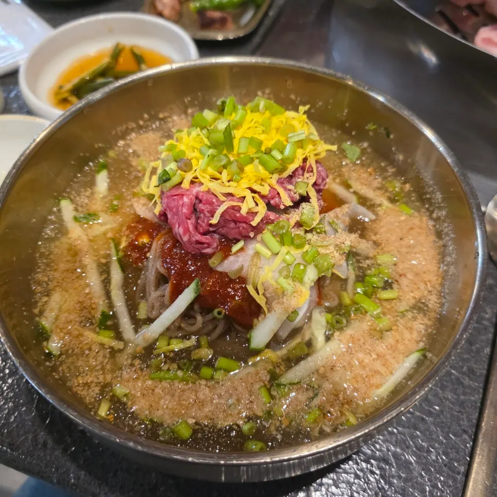 Hanwoo yukhoe naengmyeon topped with raw beef tartare and seasoning sauce