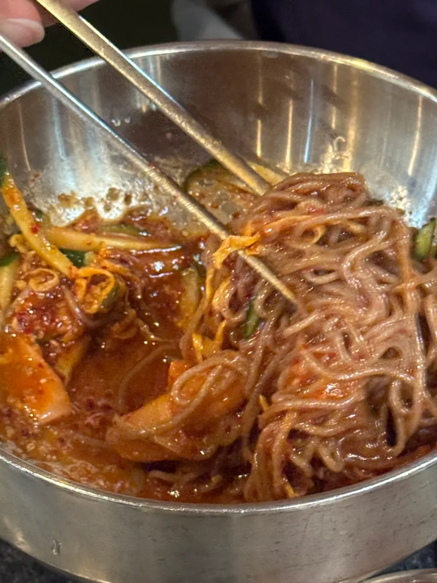 깨와 지단 고명이 올라간 비빔냉면