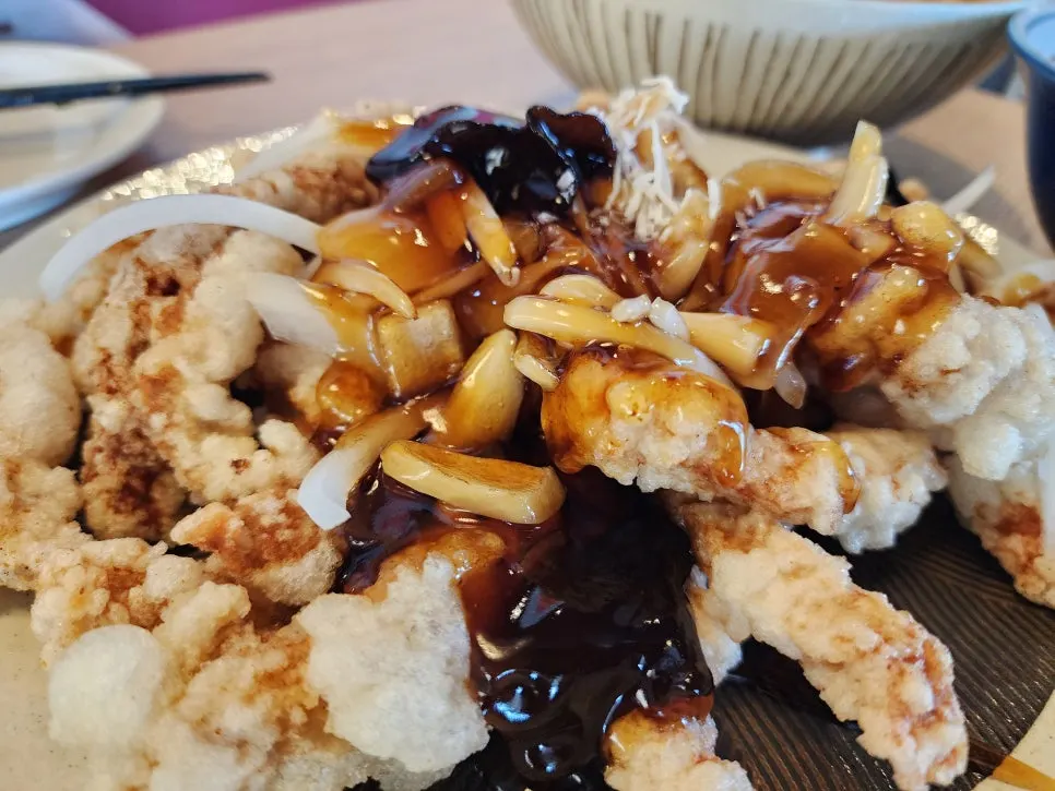 Close-up of tangsuyuk coated in black vinegar sauce