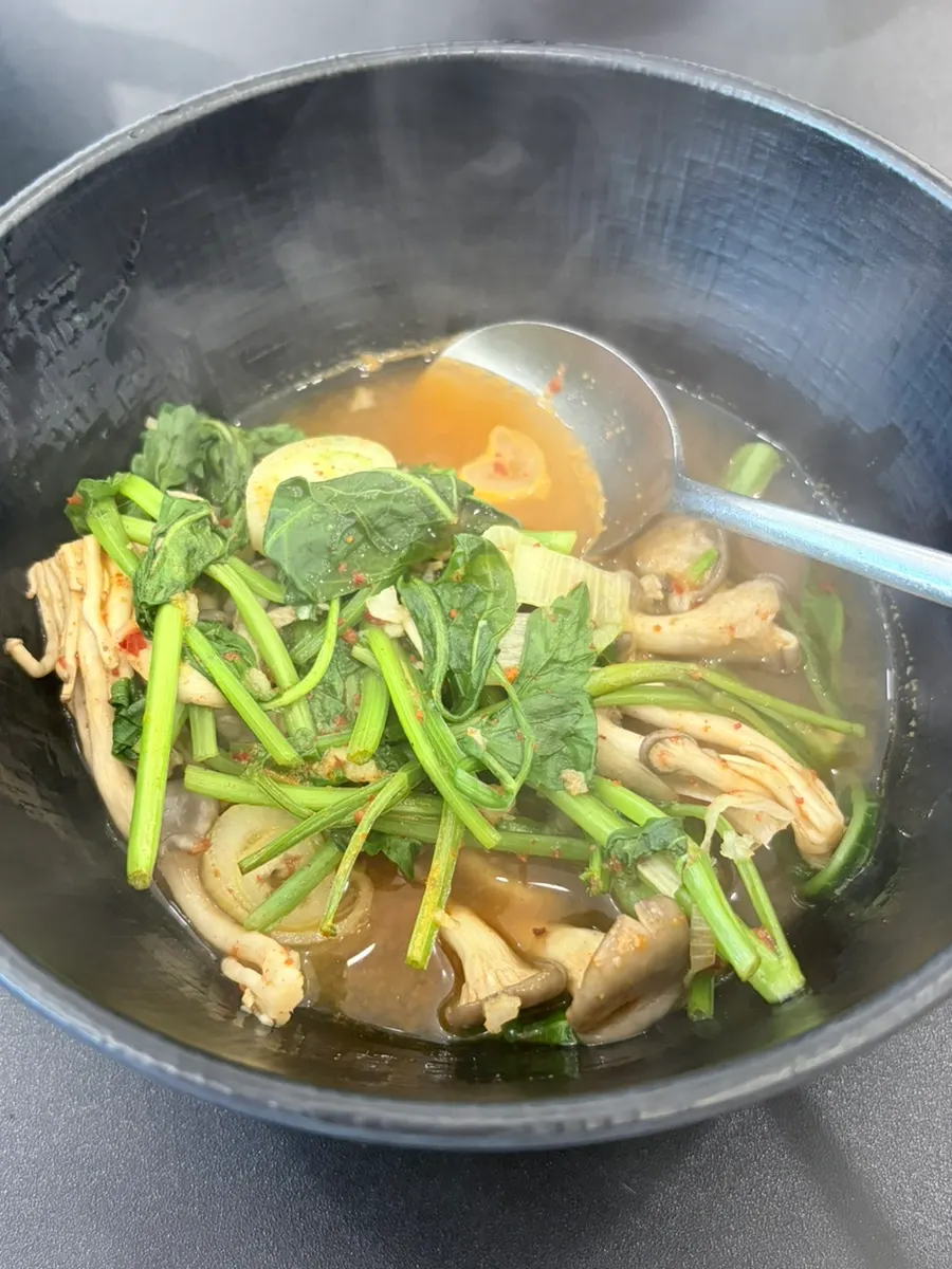 Scooping out shabu-shabu vegetables and meat