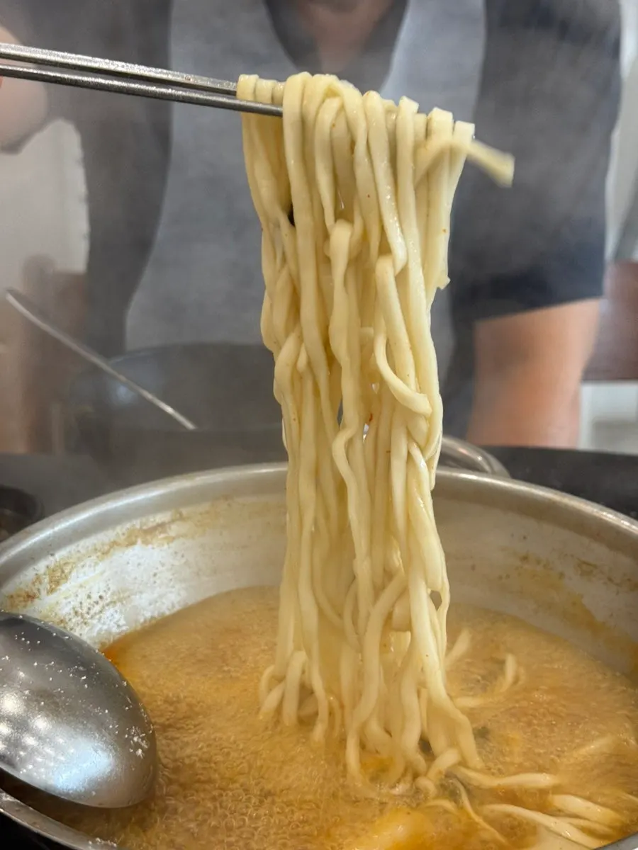 Chewy flat kalguksu noodles with fresh kimchi