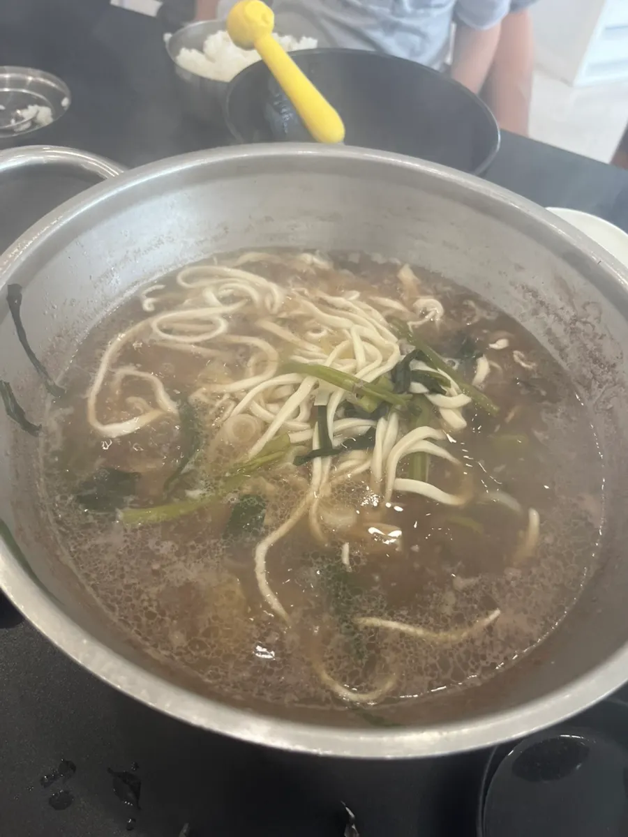 Flat kalguksu noodles eaten wrap-style