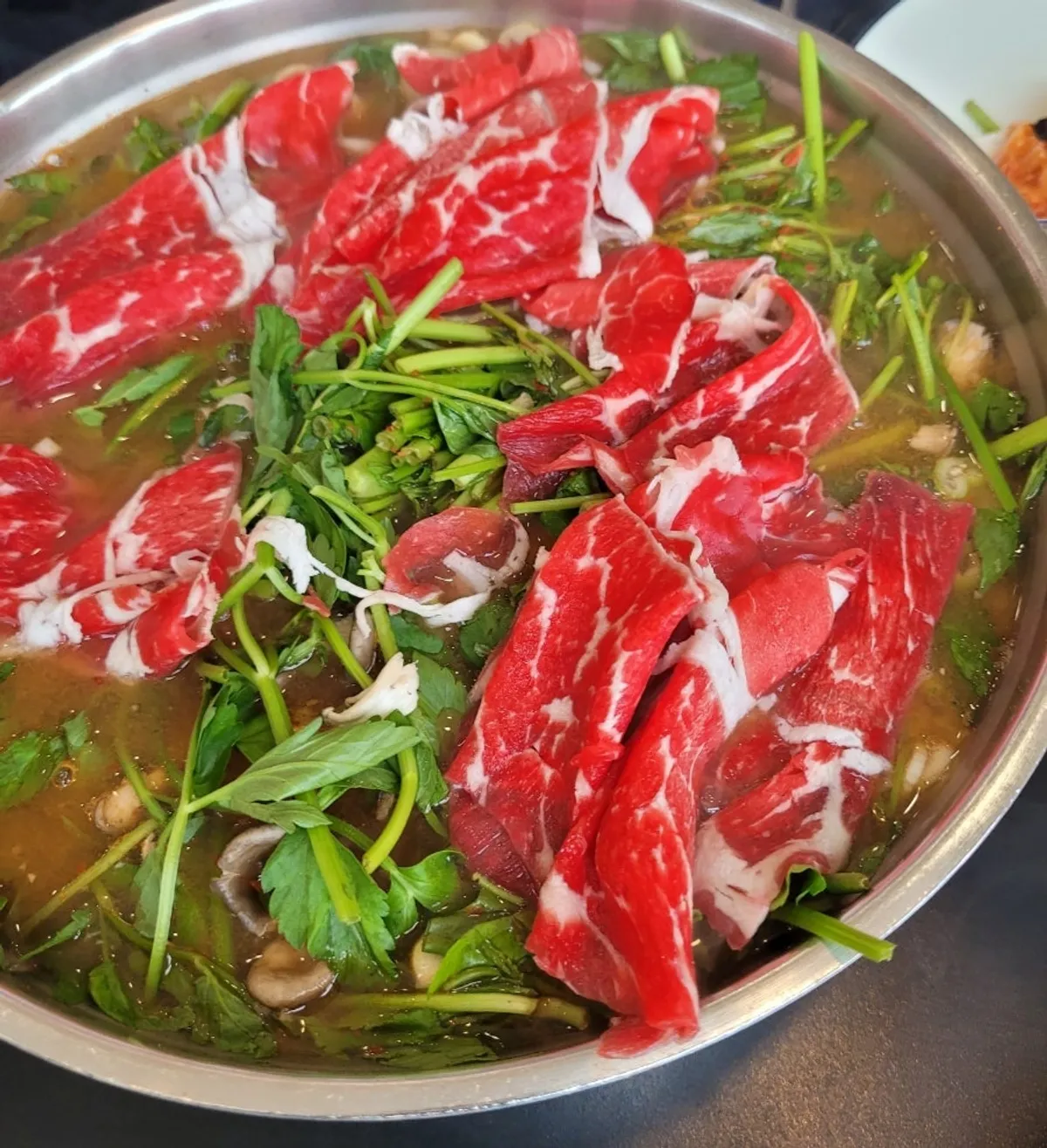 Red broth shabu-shabu table setting at Yun Ujae Shabu Kalguksu