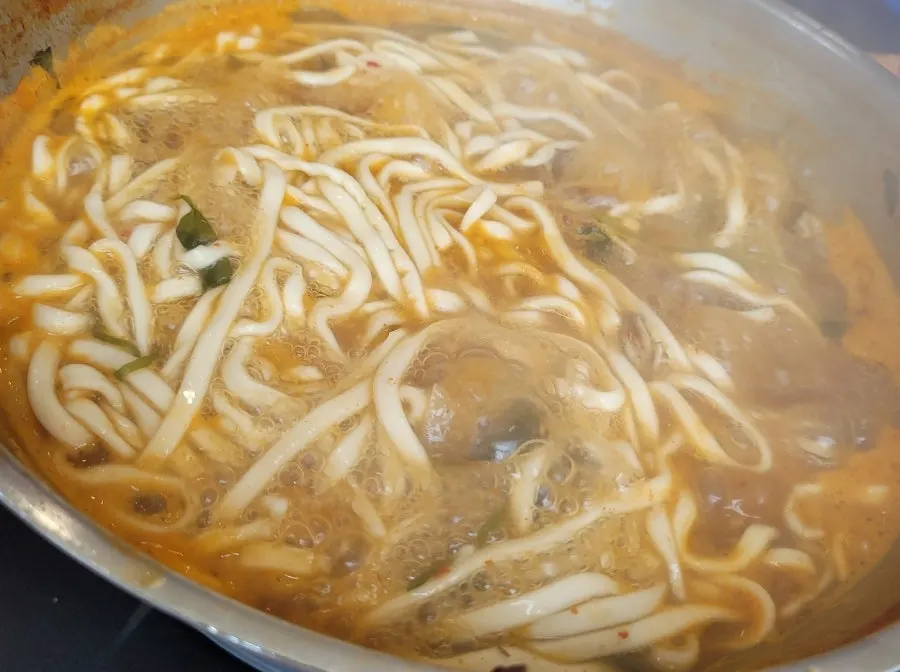 Bowl of kalguksu noodles soaked in broth