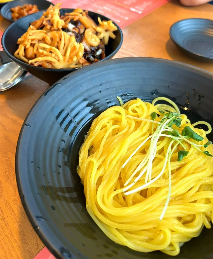 Noodles and seafood pieces in the seafood ganjjajang