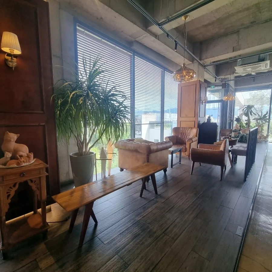 First-floor seating with wooden furniture and plants