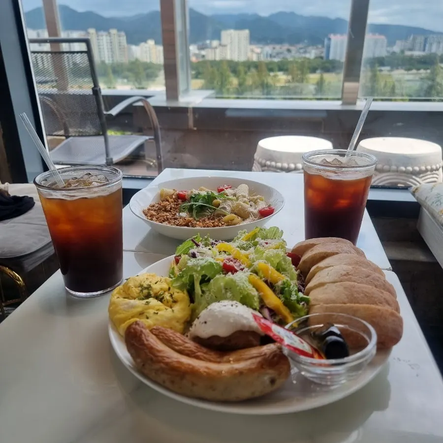 Brunch plate with bread, sausage, and scrambled eggs