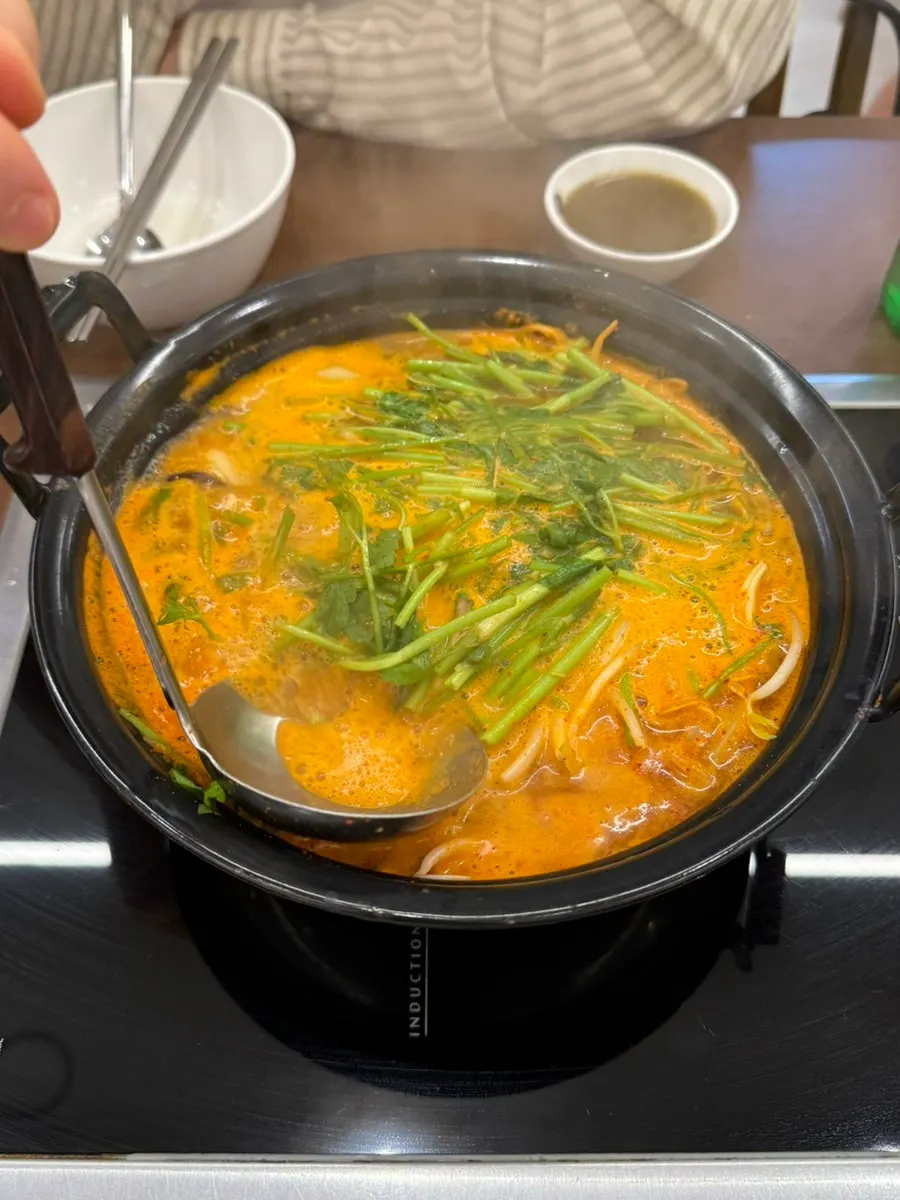 Spicy shabu broth starting to boil vigorously