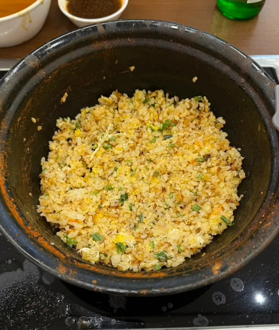 Pot being prepared for fried rice after finishing the noodles