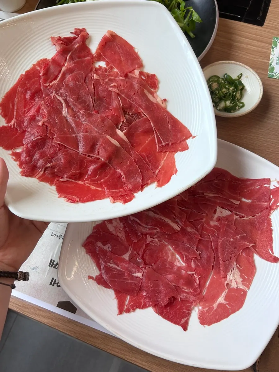Pot of clear broth shabu with meat