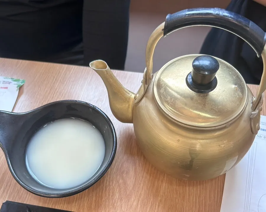 Kettle of unlimited makgeolli served at the table