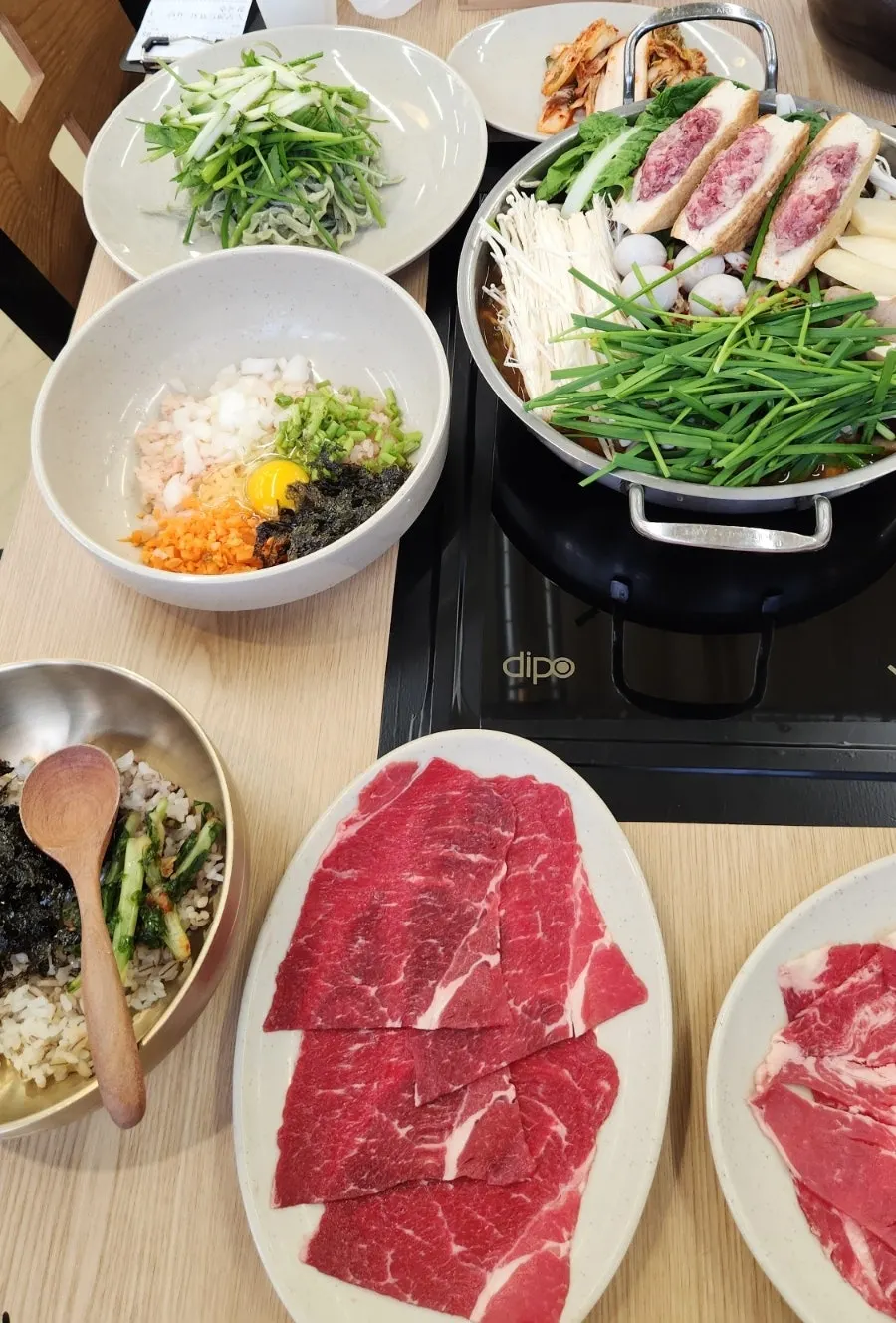 The self-serve bar with extra broth, sauces, cheongyang chili, and kimchi